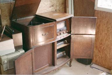 Radio cabinet with doors opened to show AM/SW radio, phonograph/record maker and the speaker grille